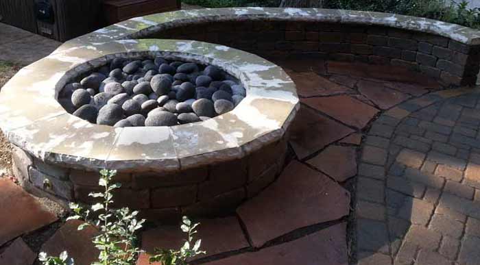 Stone Capped Firepit | Backyard Paved Patio with Curved Wall