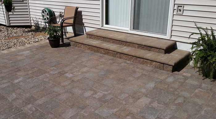 Paved Patio | Stone Capped Stairs | River Rock flower bed