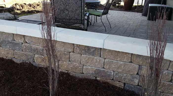 Stone Capped Wall Paved Patio Landscape Design | Omaha Nebraska