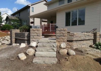 firepit-with-stone-paved-patio-and-capped-stone-wall-1
