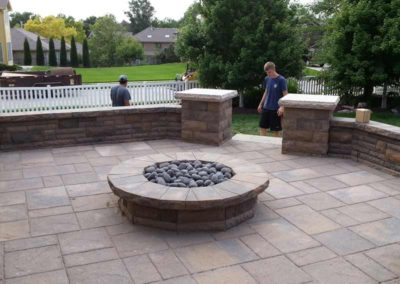 firepit-with-stone-paved-patio-and-capped-stone-wall-9