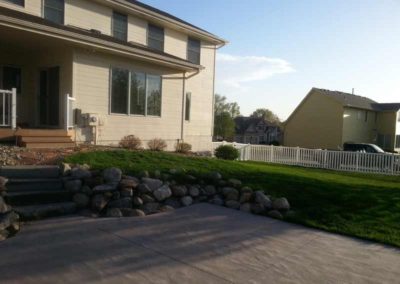 firepit-with-stone-paved-patio-and-capped-stone-wall-before-2